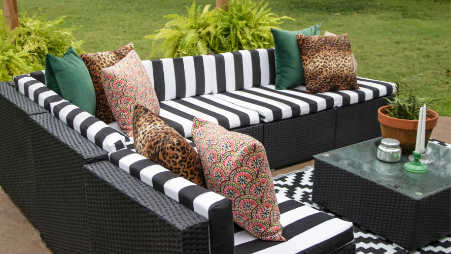 White and black striped patio couch with accent pillows.