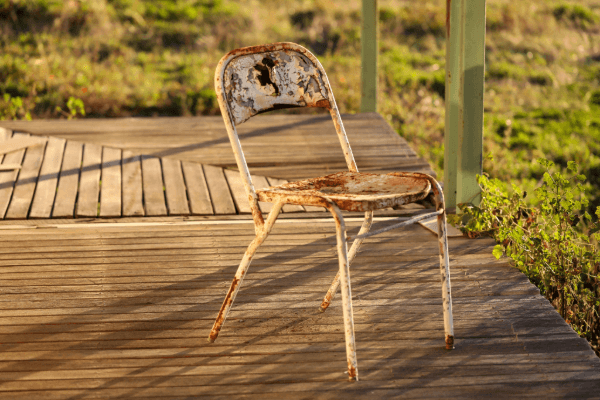 Rusty Old Metal Chair On Wooden Porch (1)